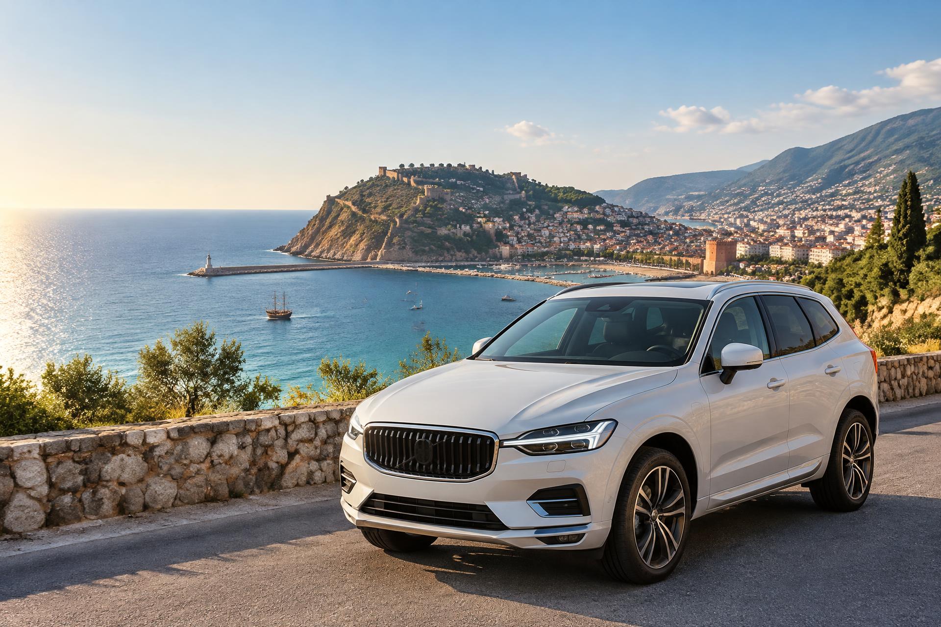 A white rental car overlooking Alanya Castle and the Mediterranean coast